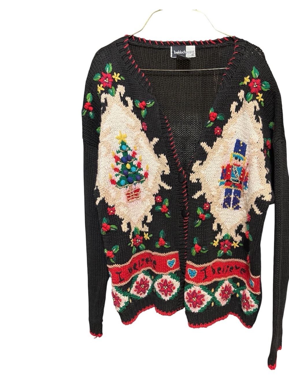 This is a vintage Beldoch Popper black knit holiday cardigan featuring a festive